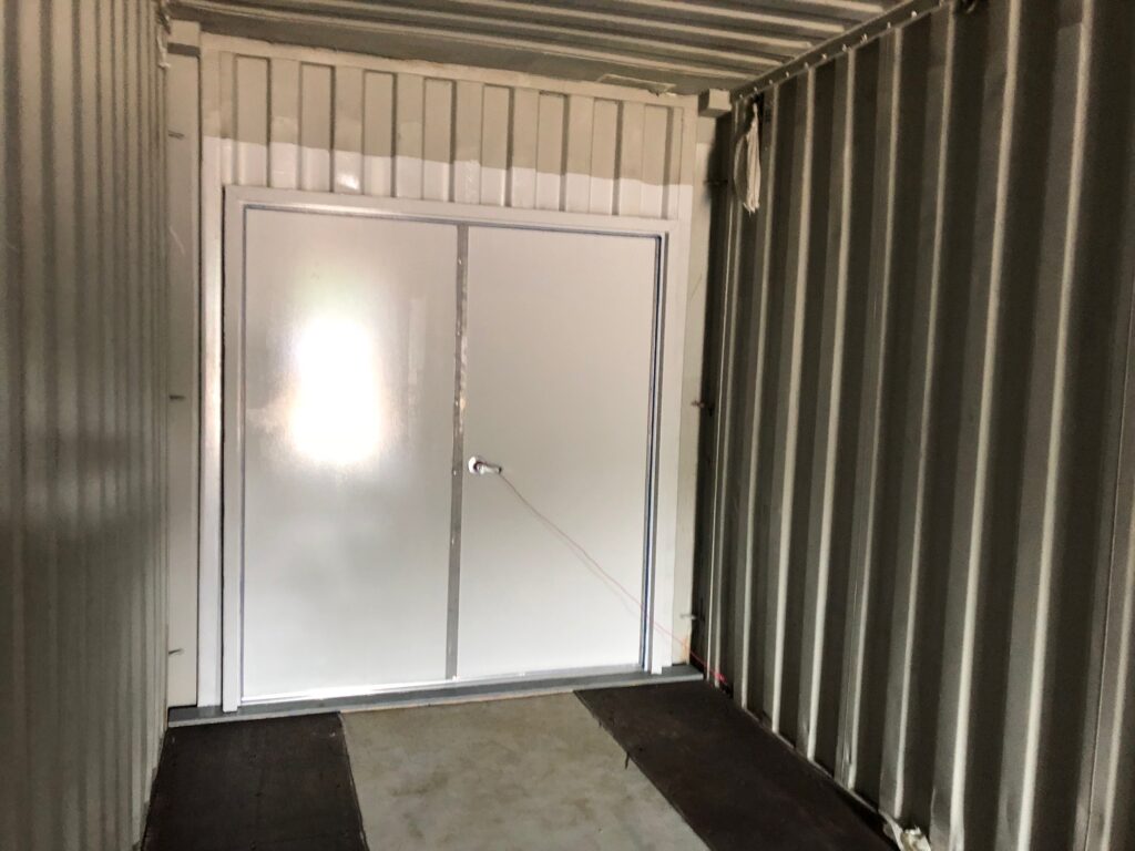 Freight container modified to include 6068 personnel doors on the front of the of the container (interior view)