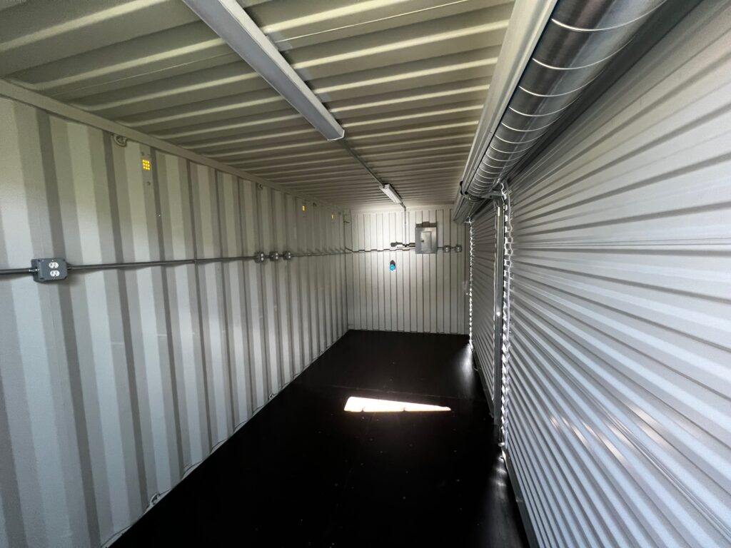 Custom milvan container with roll up doors, electrical components, and Meltric plugs (inside - front)