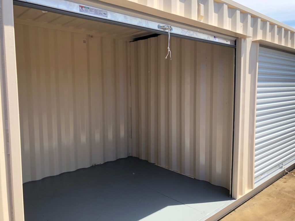 40' cargo container with several roll up doors and interior partition walls to form separate compartments (exterior -open door)