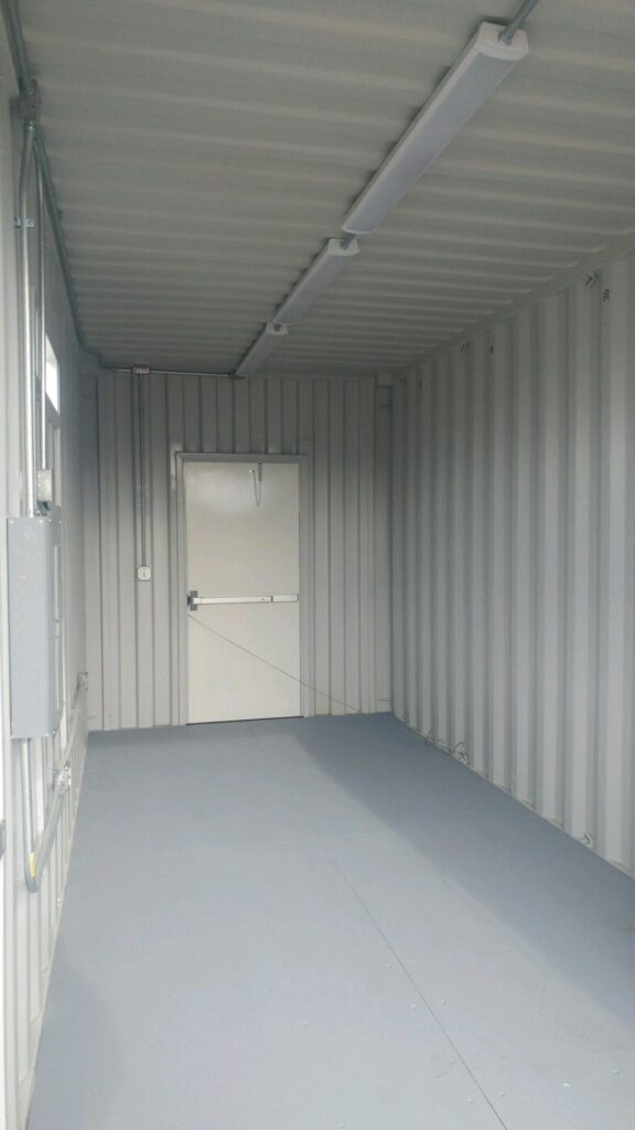 Modified conex container with HVAC system installed on the side, shipped securely inside the container for customer installation on site. Container also has 3068 personnel doors, lighting circuit breaker panel and other electrical components (interior)
